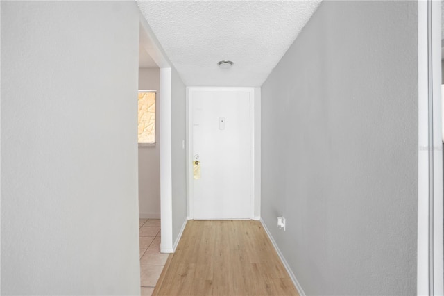 2850 N Powers Dr Unit 74, Orlando, FL 32818 - corridor featuring a textured ceiling and light wood-style flooring