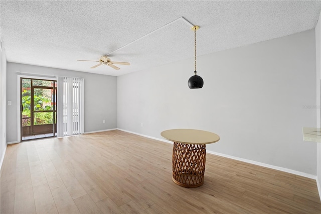 2850 N Powers Dr Unit 74, Orlando, FL 32818 - empty room featuring a ceiling fan, a textured ceiling, and light wood-type flooring