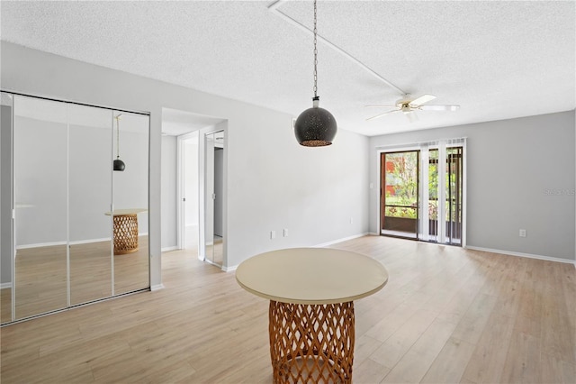2850 N Powers Dr Unit 74, Orlando, FL 32818 - unfurnished living room featuring a textured ceiling, light wood finished floors, and ceiling fan