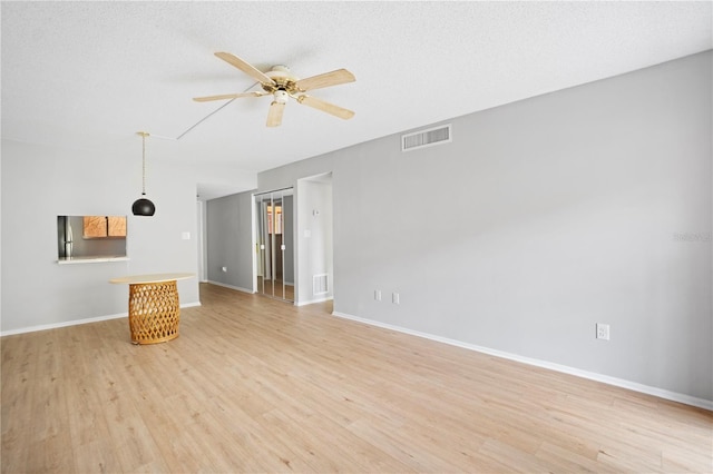 2850 N Powers Dr Unit 74, Orlando, FL 32818 - unfurnished living room with a ceiling fan and light wood-type flooring