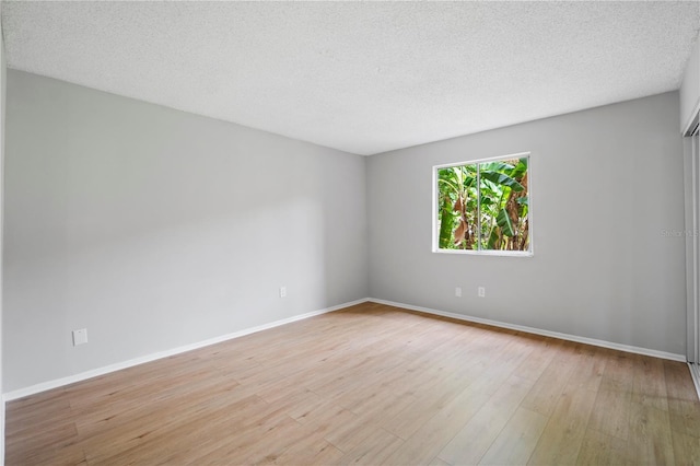 2850 N Powers Dr Unit 74, Orlando, FL 32818 - unfurnished room with light wood-style flooring and a textured ceiling