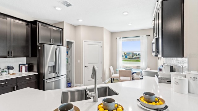 4792 Waltham Forest Dr, Davenport, FL 33837 - kitchen with appliances with stainless steel finishes, light countertops, tasteful backsplash, and recessed lighting