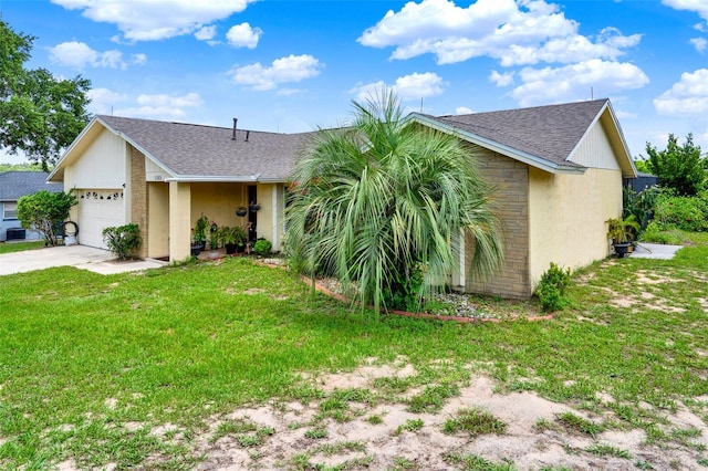1165 Indian Ridge Trl E, Kissimmee, FL 34747 - single story home with a shingled roof, a garage, a front yard, concrete driveway, and stucco siding