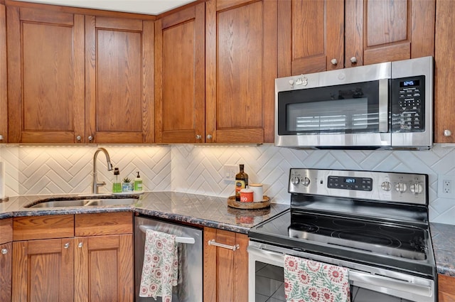 1165 Indian Ridge Trl E, Kissimmee, FL 34747 - kitchen featuring stainless steel appliances, brown cabinets, and dark stone counters