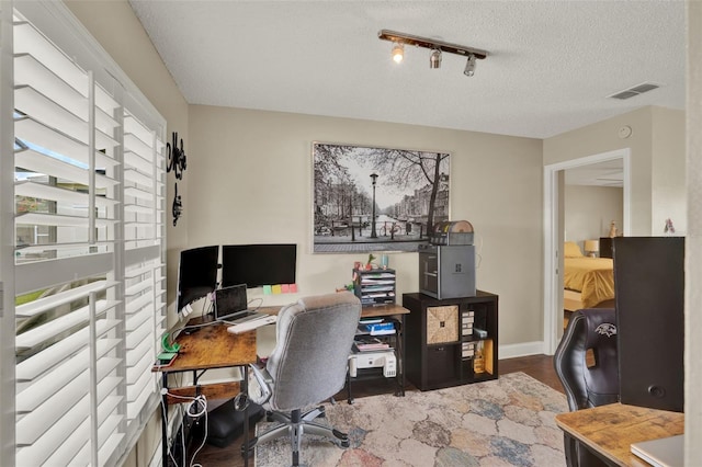 1165 Indian Ridge Trl E, Kissimmee, FL 34747 - home office featuring wood finished floors, a textured ceiling, and rail lighting