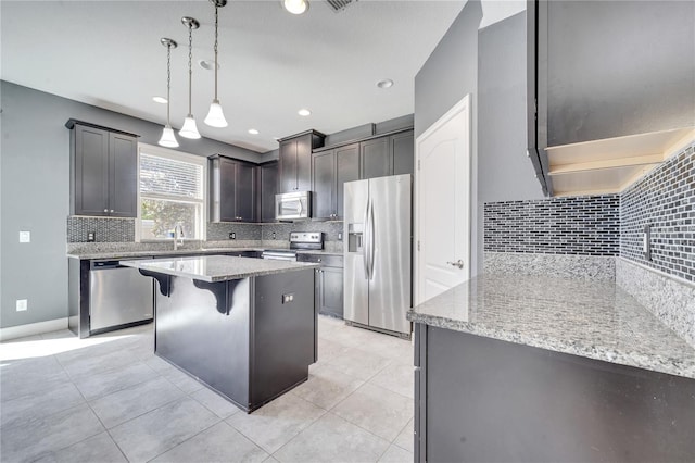 14088 Tarvin St, Orlando, FL 32832 - kitchen featuring appliances with stainless steel finishes, decorative backsplash, a center island, and recessed lighting