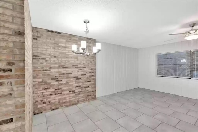 15609 Timberline Dr, Tampa, FL 33624 - unfurnished dining area with a chandelier, ceiling fan, brick wall, and tile patterned flooring