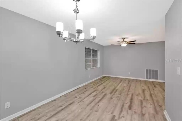 15609 Timberline Dr, Tampa, FL 33624 - unfurnished room with a chandelier, ceiling fan, and wood finished floors
