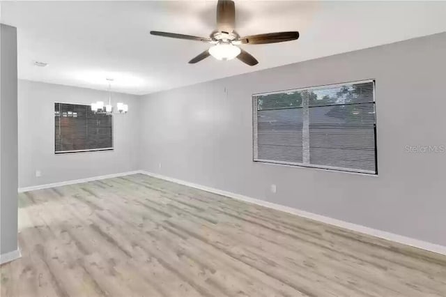 15609 Timberline Dr, Tampa, FL 33624 - unfurnished room featuring a chandelier, ceiling fan, and wood finished floors