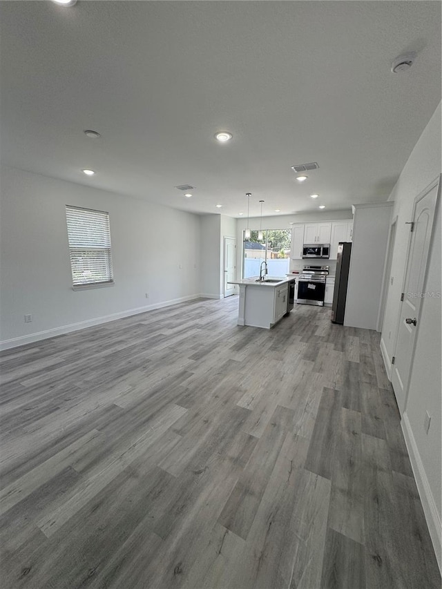 320 W Necho Ave, Lake Alfred, FL 33850 - unfurnished living room with recessed lighting and wood finished floors