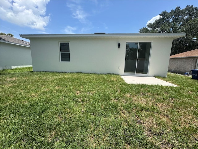 320 W Necho Ave, Lake Alfred, FL 33850 - back of house with a lawn, a patio, and stucco siding