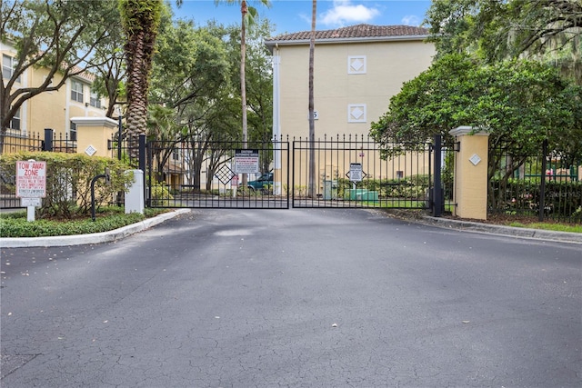 1825 Shadow View Cir Unit 1825, Maitland, FL 32751 - view of asphalt road with a gate, a gated entry, and curbs