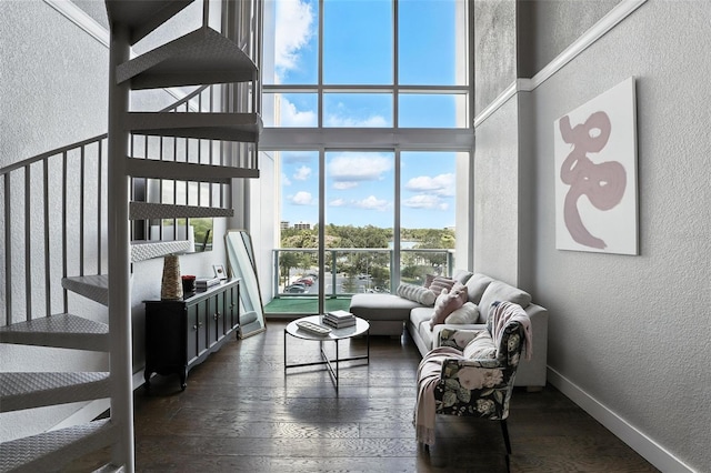 150 E Robinson St Unit 407, Orlando, FL 32801 - living area with a textured wall, a high ceiling, and dark wood finished floors