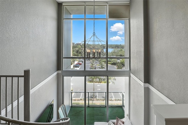 150 E Robinson St Unit 407, Orlando, FL 32801 - staircase featuring a textured wall, a chandelier, and a towering ceiling