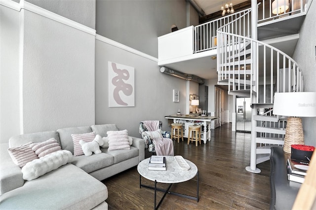 150 E Robinson St Unit 407, Orlando, FL 32801 - living room featuring a towering ceiling, hardwood / wood-style flooring, a chandelier, stairs, and a textured wall