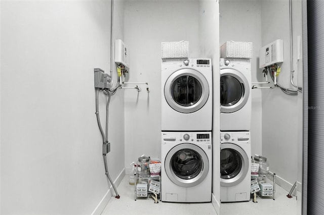 150 E Robinson St Unit 407, Orlando, FL 32801 - laundry room with estacked washer and dryer and baseboards