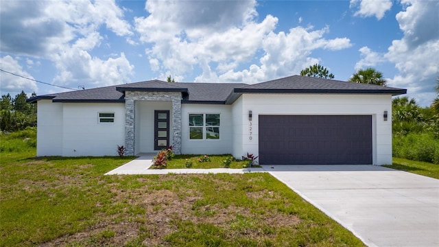3270 Framinghan Ave SW, Palm Bay, FL 32908 - prairie-style home with an attached garage, a front lawn, driveway, and stucco siding