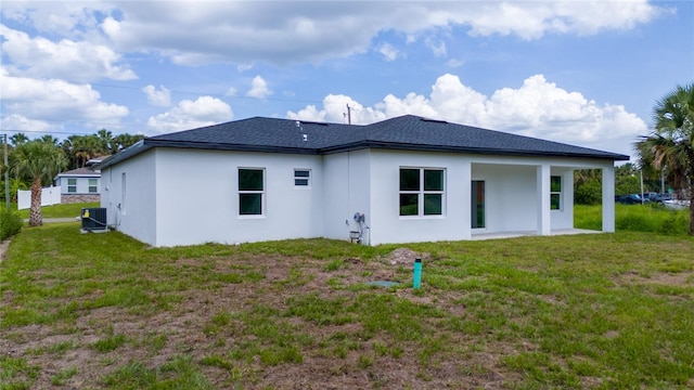 3270 Framinghan Ave SW, Palm Bay, FL 32908 - rear view of house featuring stucco siding, a lawn, and roof with shingles