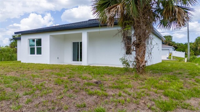 3270 Framinghan Ave SW, Palm Bay, FL 32908 - rear view of property featuring stucco siding and a yard