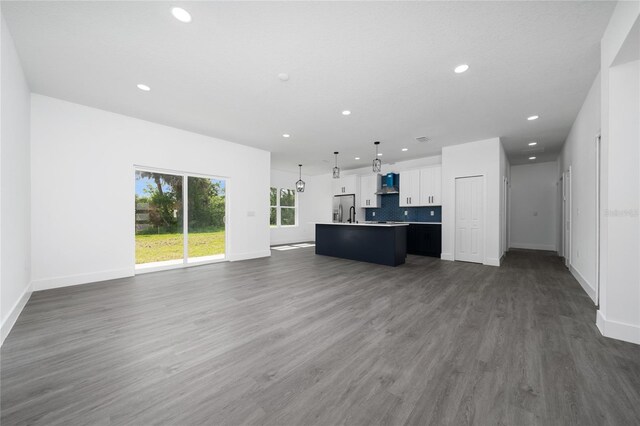 3270 Framinghan Ave SW, Palm Bay, FL 32908 - unfurnished living room with recessed lighting and dark wood-style flooring