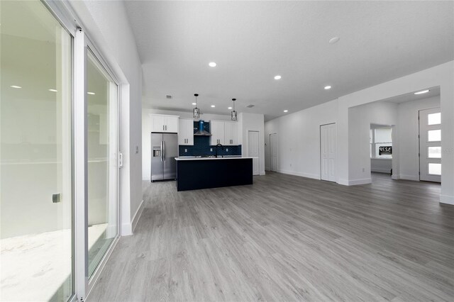 3270 Framinghan Ave SW, Palm Bay, FL 32908 - unfurnished living room with light wood-type flooring and recessed lighting