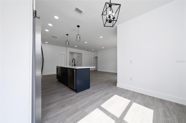 3270 Framinghan Ave SW, Palm Bay, FL 32908 - kitchen featuring appliances with stainless steel finishes, open floor plan, recessed lighting, a kitchen island with sink, and light countertops