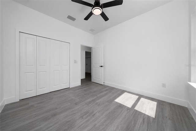 3270 Framinghan Ave SW, Palm Bay, FL 32908 - unfurnished bedroom featuring wood finished floors, a closet, and ceiling fan
