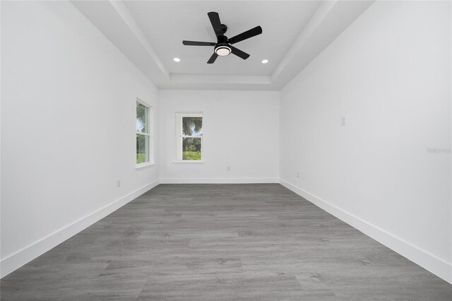 3270 Framinghan Ave SW, Palm Bay, FL 32908 - unfurnished room featuring a raised ceiling, recessed lighting, a ceiling fan, and wood finished floors