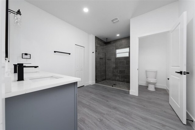 3270 Framinghan Ave SW, Palm Bay, FL 32908 - bathroom featuring tiled shower, recessed lighting, wood finished floors, and double vanity