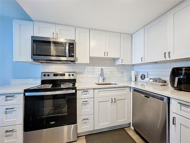 400 E Colonial Dr Unit 1501, Orlando, FL 32803 - kitchen featuring stainless steel appliances, white cabinets, light countertops, and backsplash