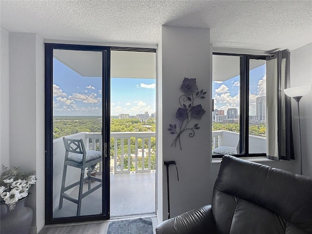 400 E Colonial Dr Unit 1501, Orlando, FL 32803 - doorway to outside with expansive windows, a textured ceiling, healthy amount of natural light, and wood finished floors