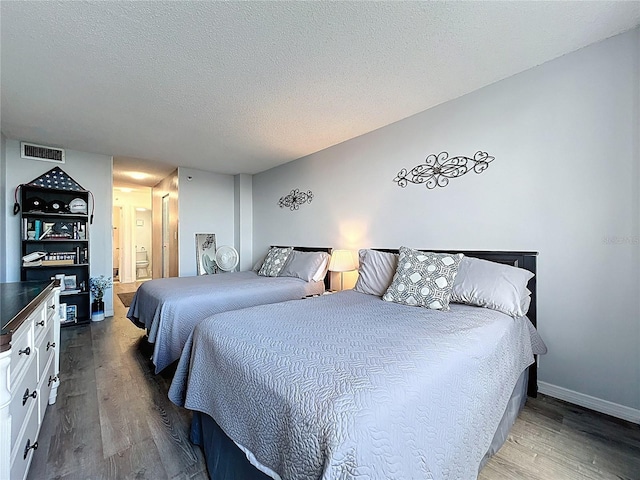 400 E Colonial Dr Unit 1501, Orlando, FL 32803 - bedroom featuring wood finished floors, a textured ceiling, and ensuite bathroom
