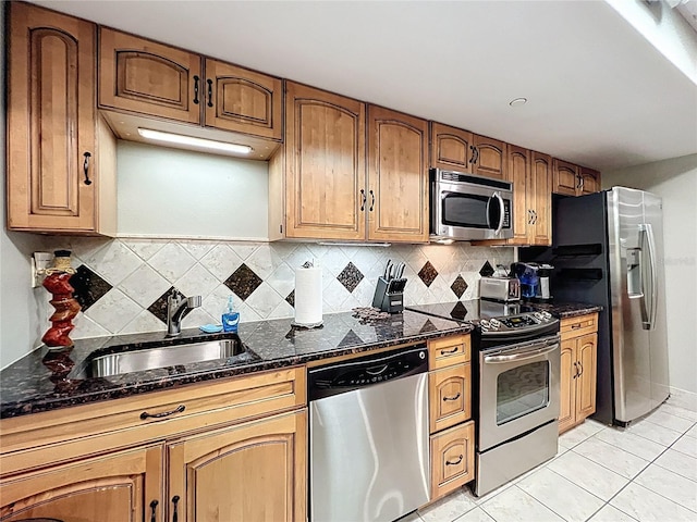 400 E Colonial Dr Unit 1501, Orlando, FL 32803 - kitchen with appliances with stainless steel finishes, backsplash, light tile patterned floors, dark stone counters, and brown cabinetry
