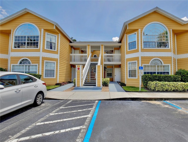 8709 Knightsbridge Ct Unit B, Kissimmee, FL 34747 - view of property with stairs and uncovered parking