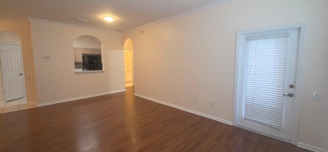 13584 Turtle Marsh Loop Unit 12, Orlando, FL 32837 - spare room featuring wood finished floors, ornamental molding, and arched walkways