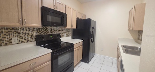 13584 Turtle Marsh Loop Unit 12, Orlando, FL 32837 - kitchen with black appliances, tasteful backsplash, light countertops, and light tile patterned floors