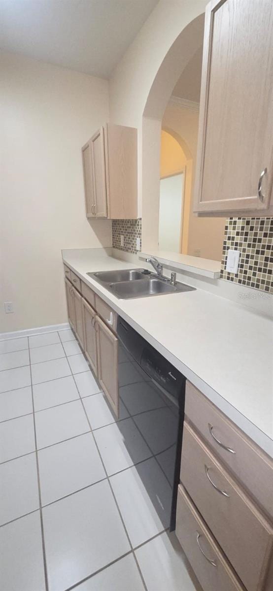 13584 Turtle Marsh Loop Unit 12, Orlando, FL 32837 - kitchen featuring dishwasher, light tile patterned flooring, backsplash, light countertops, and arched walkways