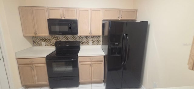 13584 Turtle Marsh Loop Unit 12, Orlando, FL 32837 - kitchen featuring black appliances, backsplash, light countertops, and light brown cabinets