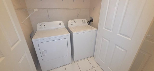 13584 Turtle Marsh Loop Unit 12, Orlando, FL 32837 - laundry room with washer and dryer and light tile patterned floors