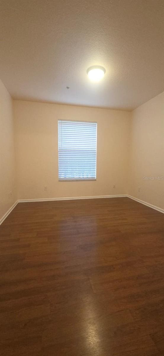 13584 Turtle Marsh Loop Unit 12, Orlando, FL 32837 - unfurnished room featuring dark wood-style flooring