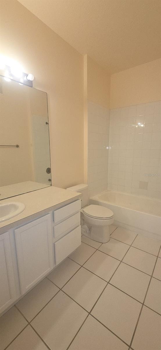 13584 Turtle Marsh Loop Unit 12, Orlando, FL 32837 - bathroom with tile patterned flooring, vanity, and a tub to relax in