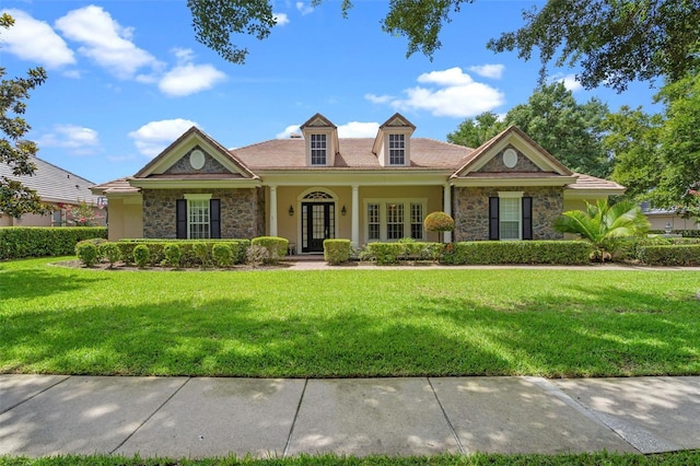25554 Hawks Run Ln, Sorrento, FL 32776 - view of front of house with stone siding, stucco siding, and a front yard
