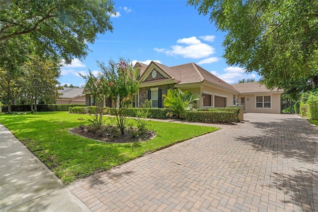 25554 Hawks Run Ln, Sorrento, FL 32776 - view of front of home with an attached garage, decorative driveway, a front lawn, stucco siding, and a tile roof