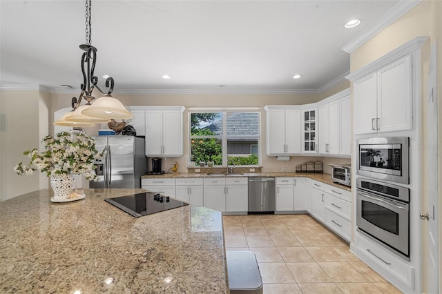 25554 Hawks Run Ln, Sorrento, FL 32776 - kitchen featuring appliances with stainless steel finishes, white cabinetry, glass insert cabinets, light stone countertops, and ornamental molding