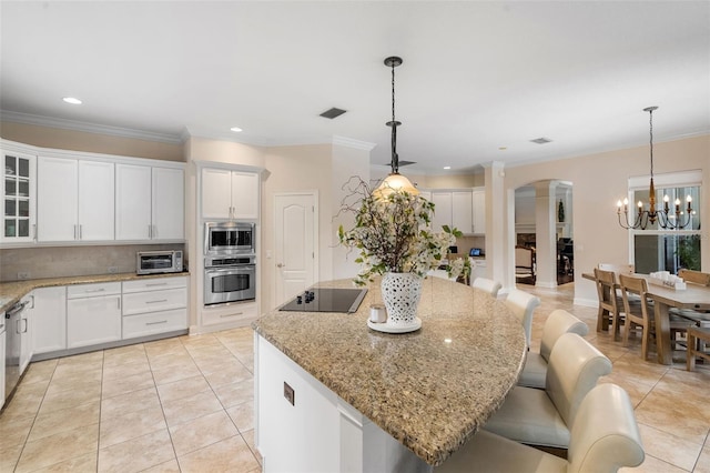 25554 Hawks Run Ln, Sorrento, FL 32776 - kitchen featuring appliances with stainless steel finishes, a chandelier, tasteful backsplash, light tile patterned flooring, and crown molding