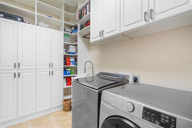 25554 Hawks Run Ln, Sorrento, FL 32776 - laundry room featuring cabinet space, independent washer and dryer, and light tile patterned floors