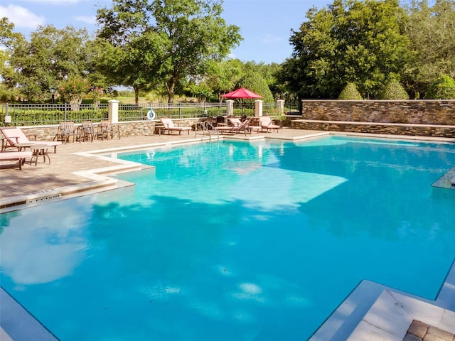 25554 Hawks Run Ln, Sorrento, FL 32776 - community pool with a patio area