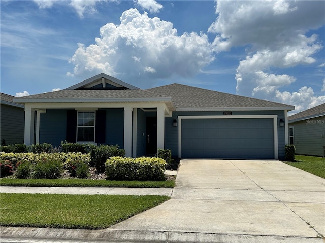 1950 Birnham Wood Bnd, Kissimmee, FL 34746 - view of front facade featuring a garage, concrete driveway, and roof with shingles