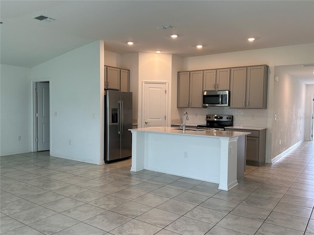 1950 Birnham Wood Bnd, Kissimmee, FL 34746 - kitchen featuring stainless steel appliances, gray cabinets, light tile patterned flooring, tasteful backsplash, and recessed lighting