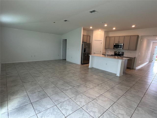 1950 Birnham Wood Bnd, Kissimmee, FL 34746 - kitchen featuring stainless steel appliances, open floor plan, light tile patterned floors, recessed lighting, and a center island with sink